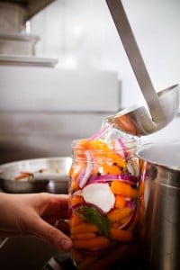 When sugar & salt is dissolved, ladle the liquid into the jars