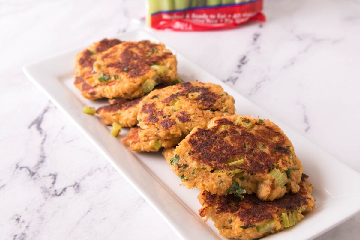 vertical shot of crab cakes on a white serving platter