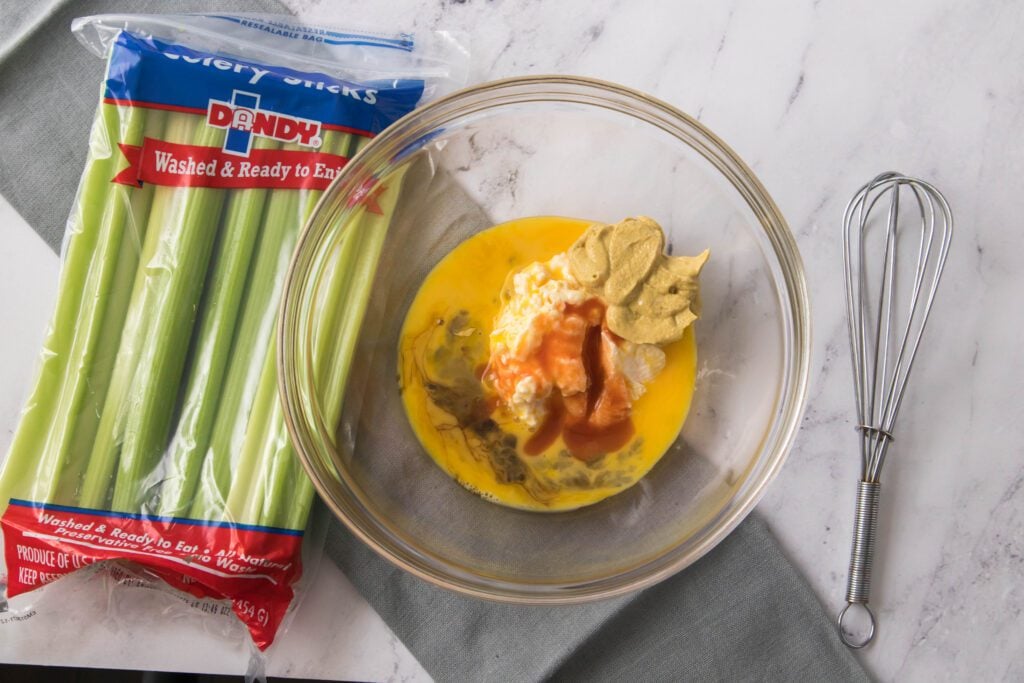 Wet ingredients for crab cakes in a bowl