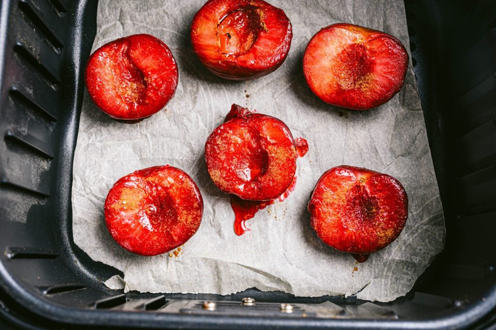 Flesh side up of Plumsciles in air fryer