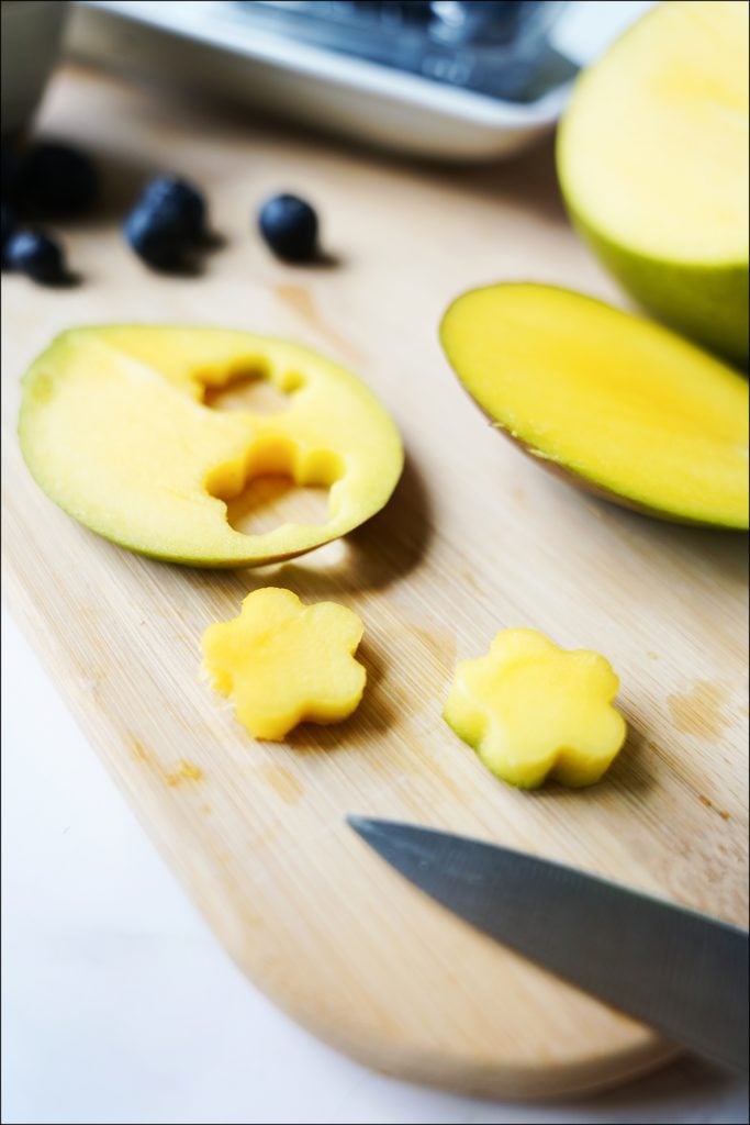 sliced mango with flower cut out using cookie cutter