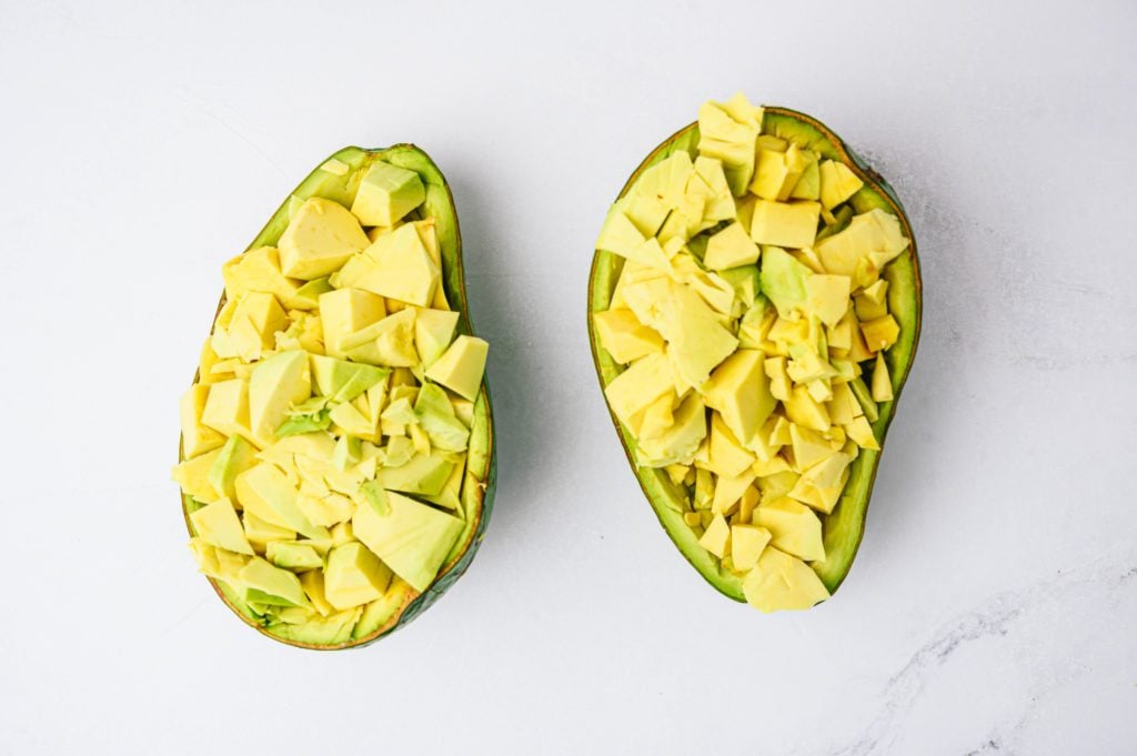 diced tropical avocado in avocado skin