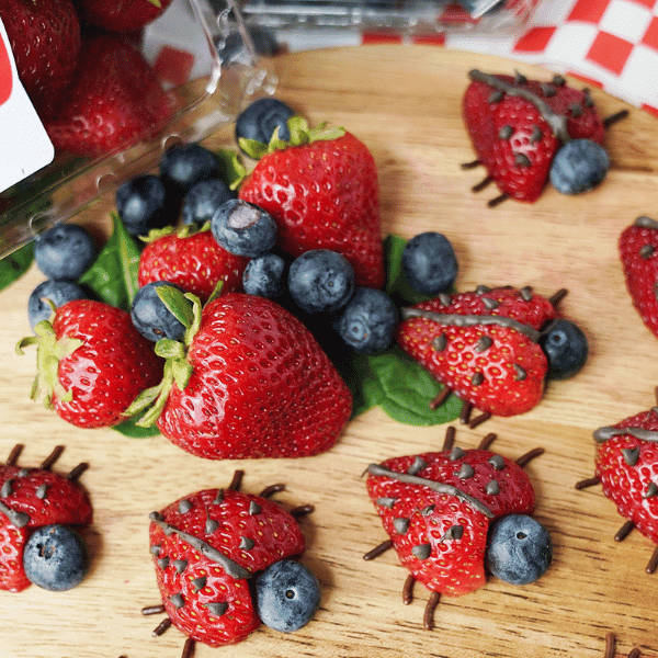 Strawberry Ladybugs on wood board on table