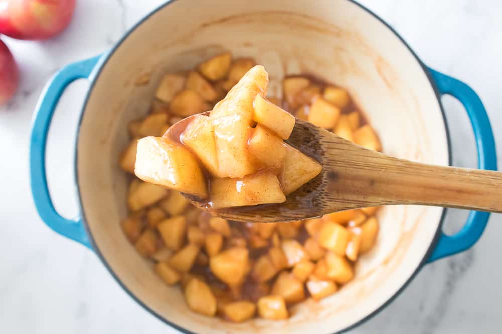 wooden spoon with scoop of apple pie filing