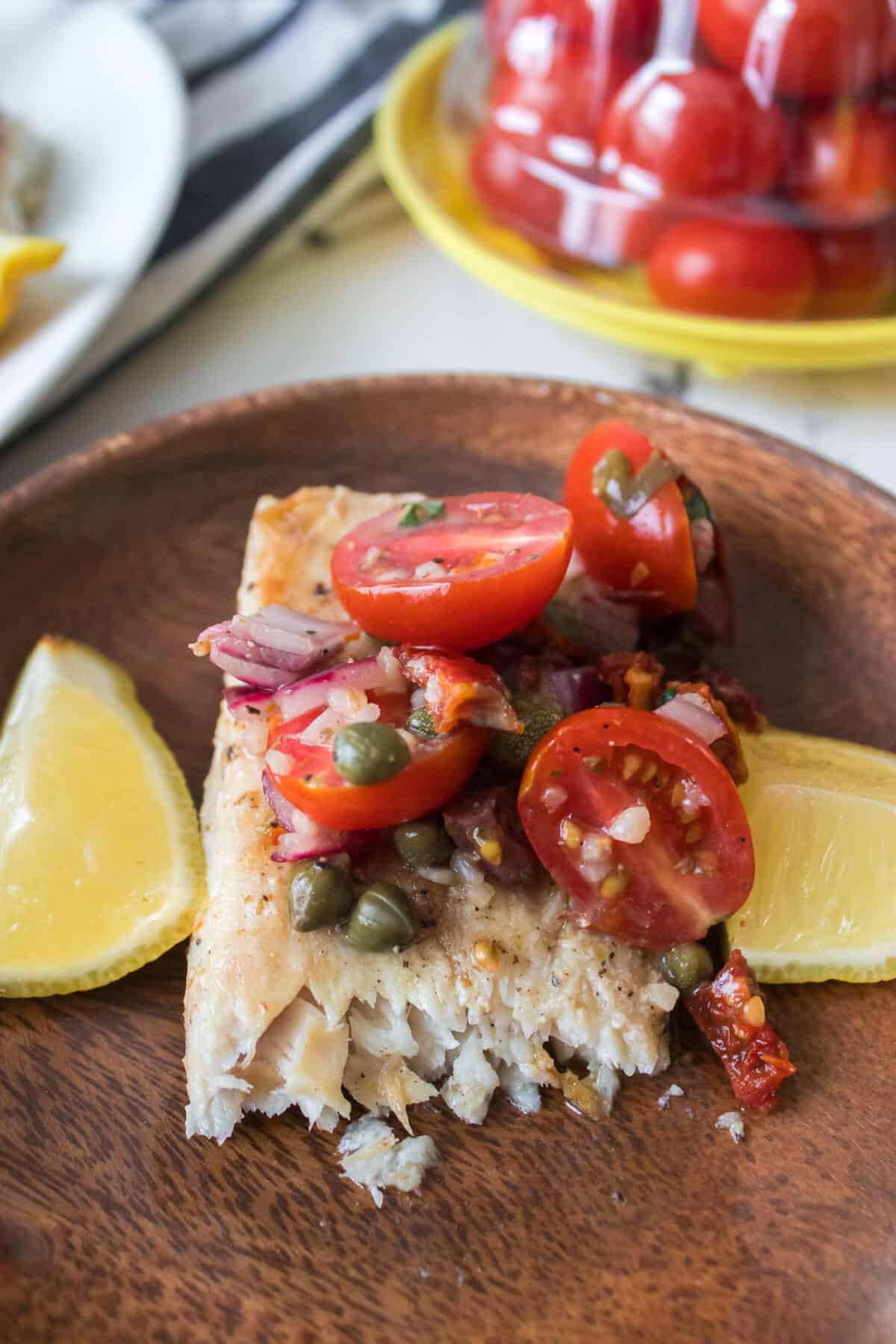 close up shot of Mediterranean fish with tapenade with bike taken out of it