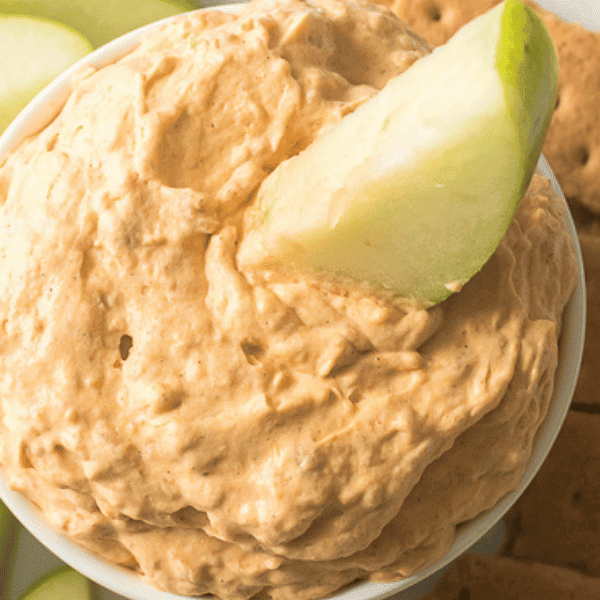 Close up of apple slice in pumpkin fluff dip