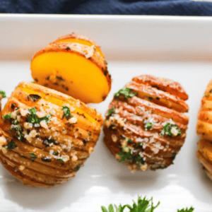 Hasselback Potatoes on white plate