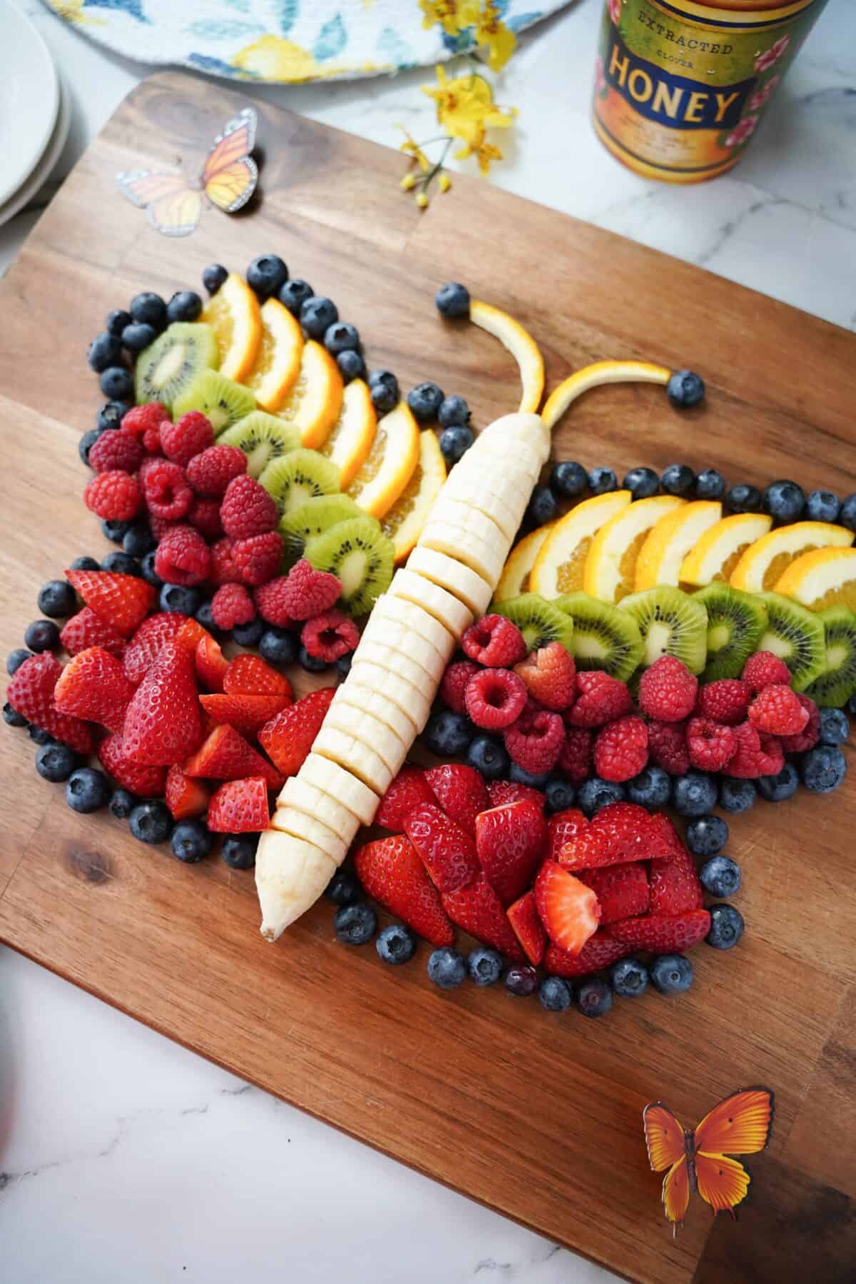 overhead view of butterfly fruit board