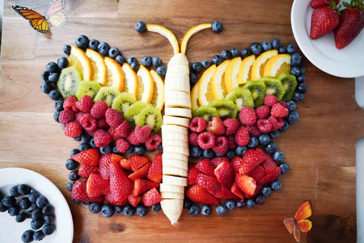 overhead shot of a butterfly fruit platter on serving board