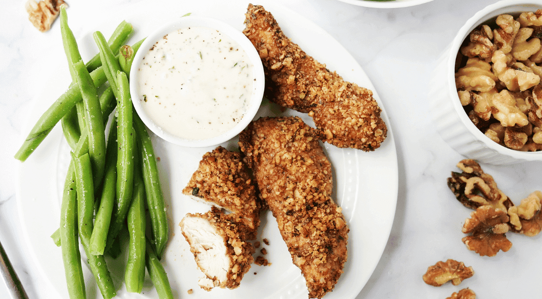 Air Fryer Chicken Tenders with Walnut Crusts on plate with green beans