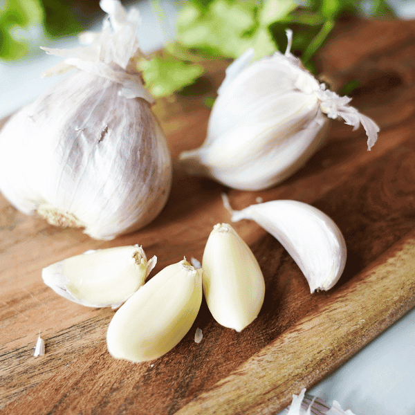 Garlic bulb and cloves on cutting board