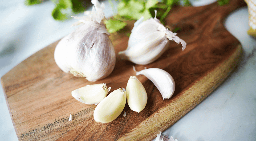 Garlic bulb and cloves on cutting board