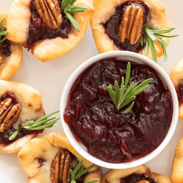 Cranberry Brie bites on a plate with cranberry jelly