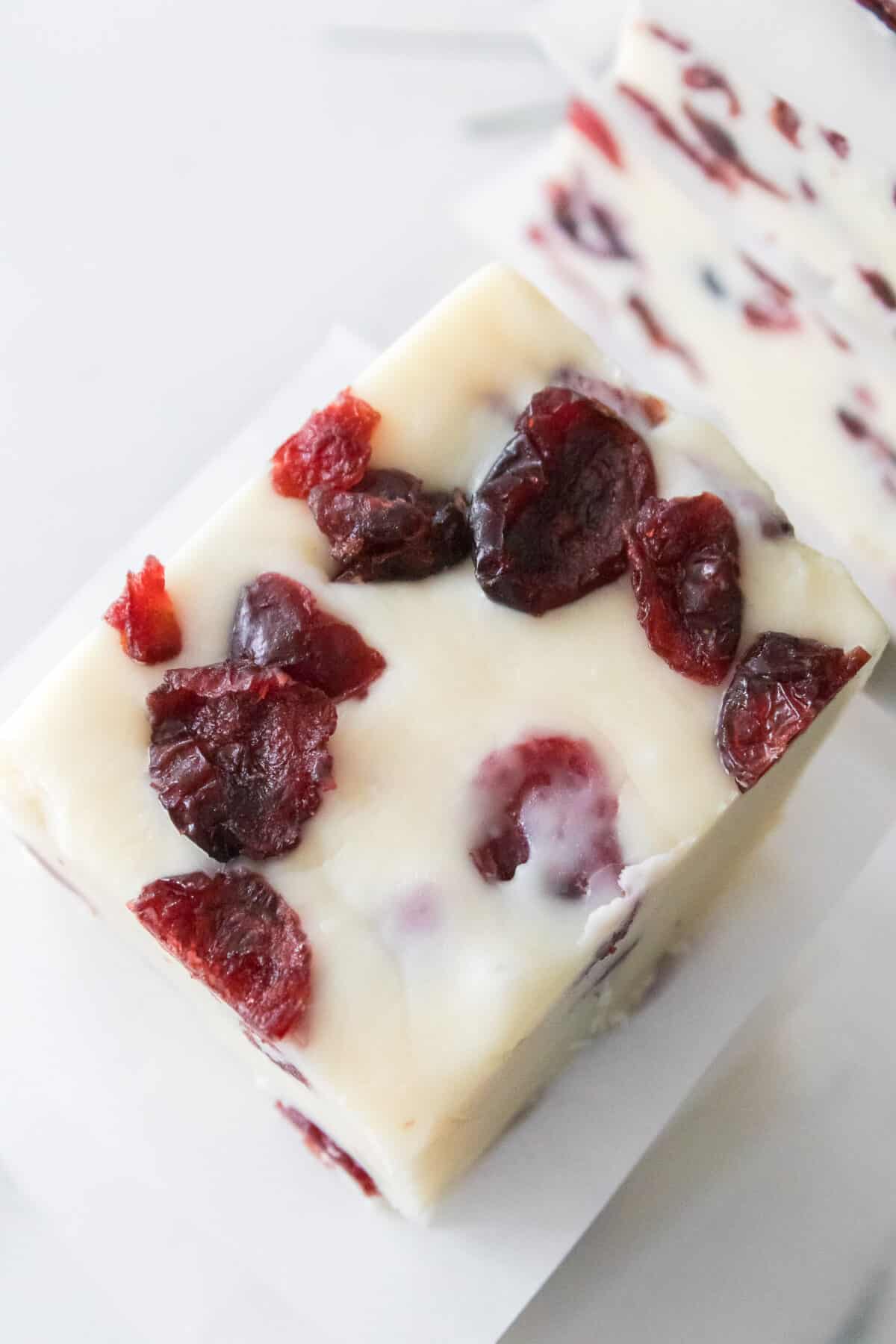 overhead shot of top of cranberry fudge with pieces of dried cranberries on top