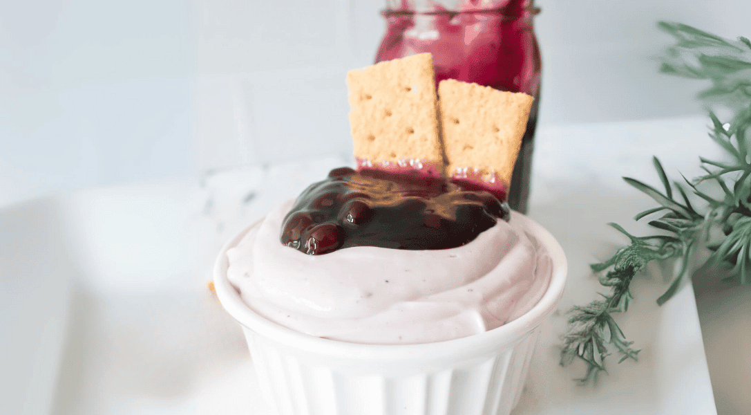 Blueberry Cheesecake dip with graham crackers in bowl