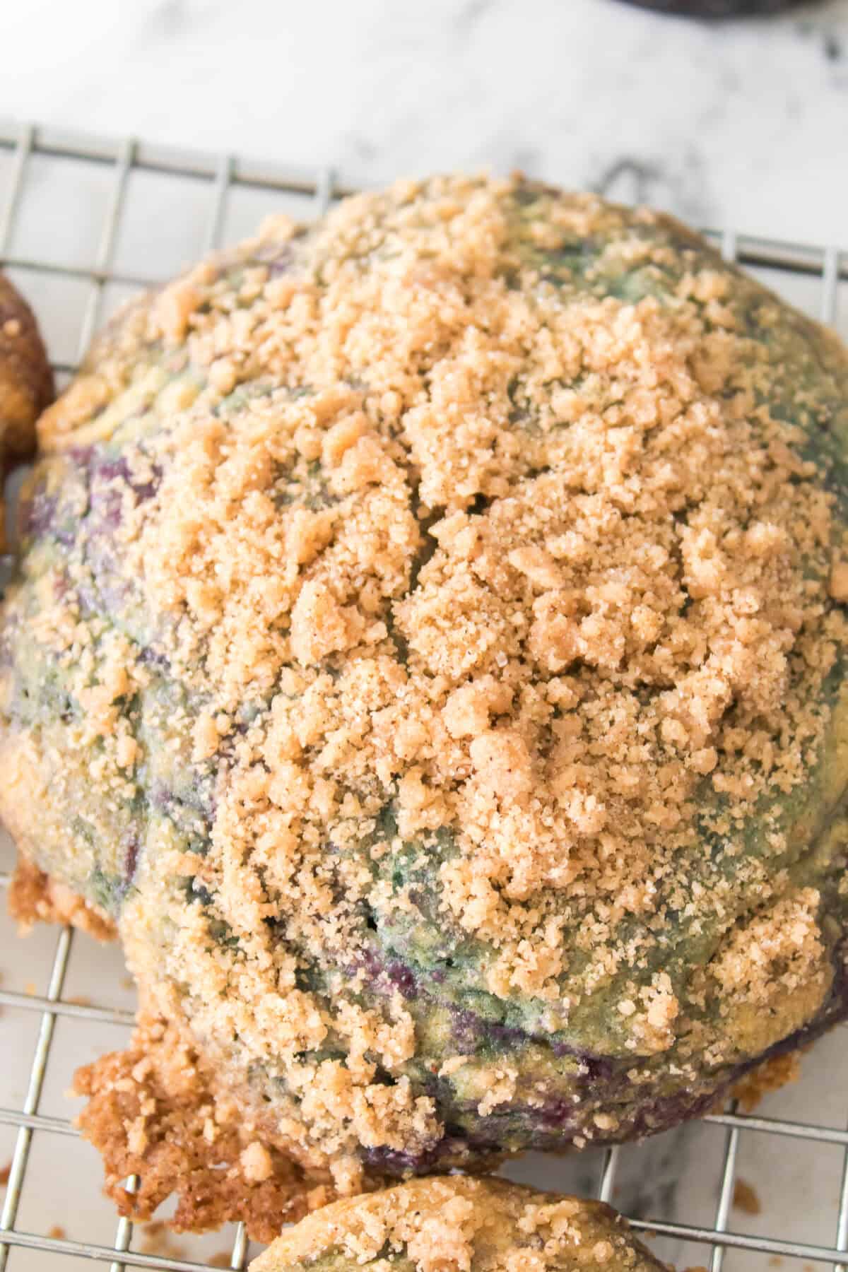 close up shot of streusel topping on Homemade Copycat Crumbl Blueberry Muffin Cookies