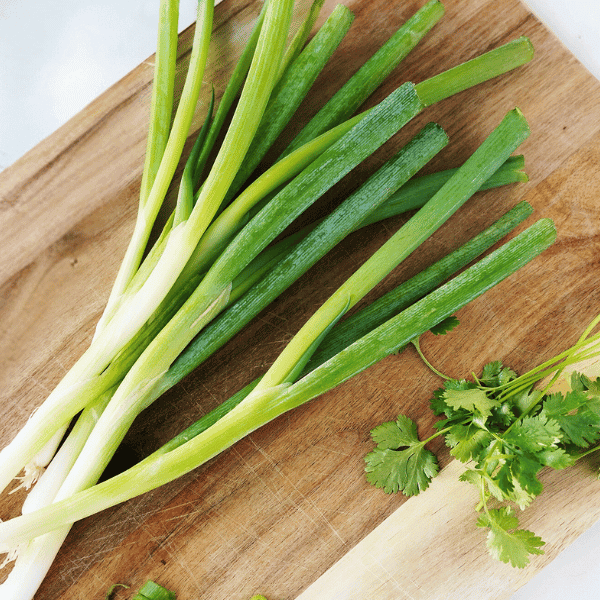 Green onions on cutting board