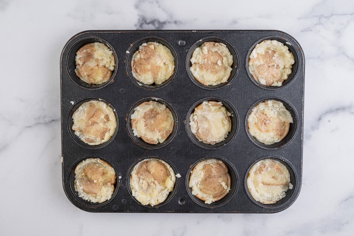 smashed potatoes in a muffin tin