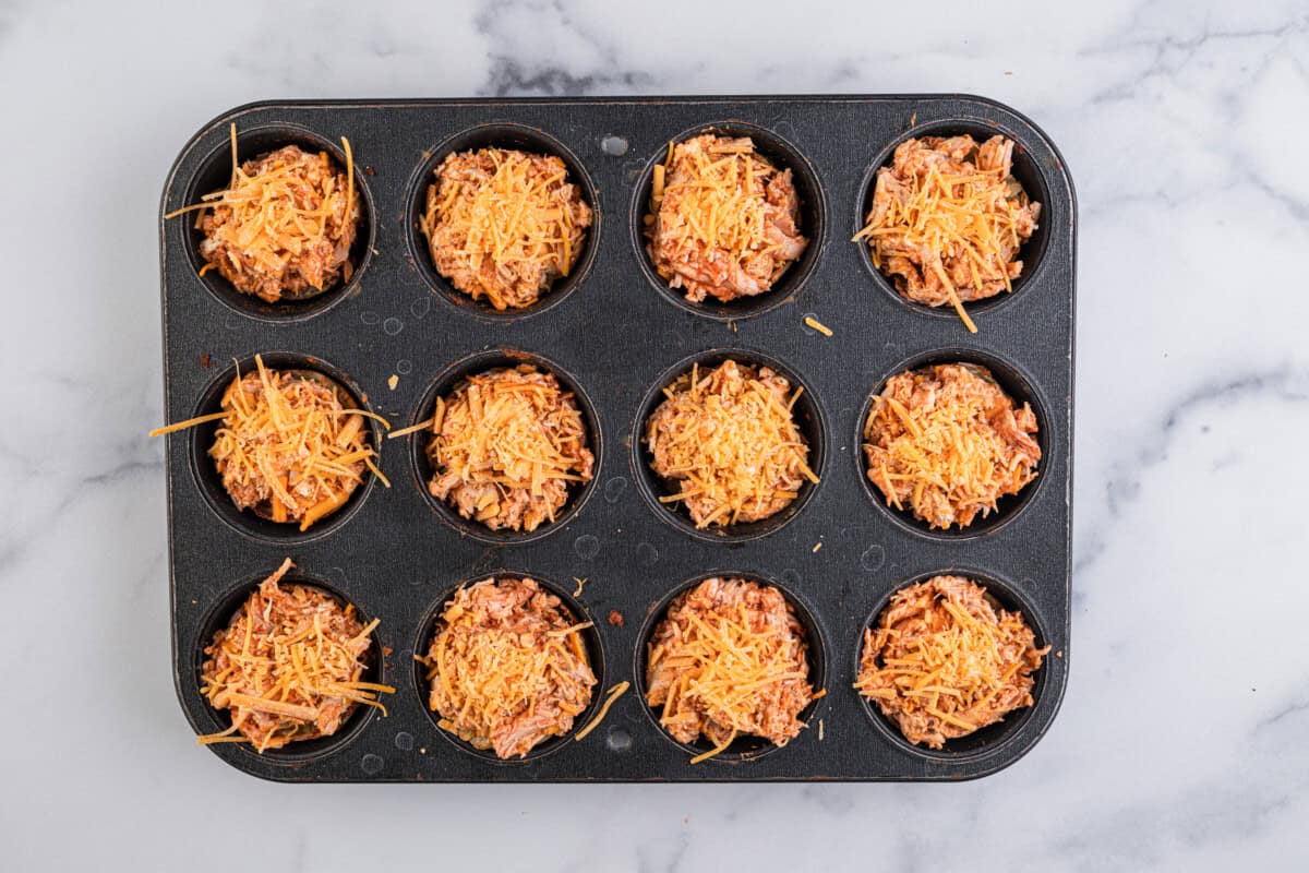 buffalo chicken mixture topped with shredded cheese before baking