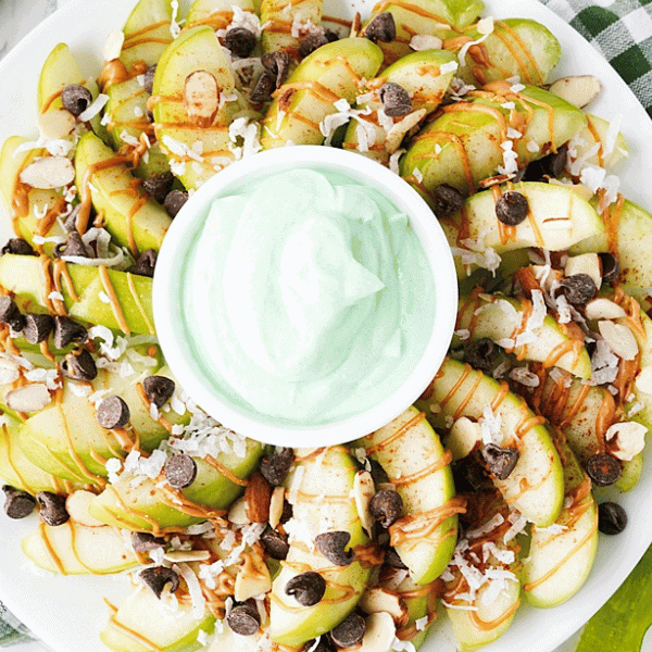 Green apple nachos with green fruit dip in the middle