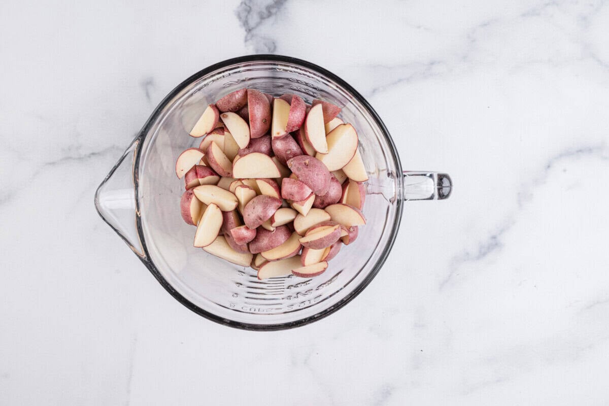 Raw, quartered potatoes