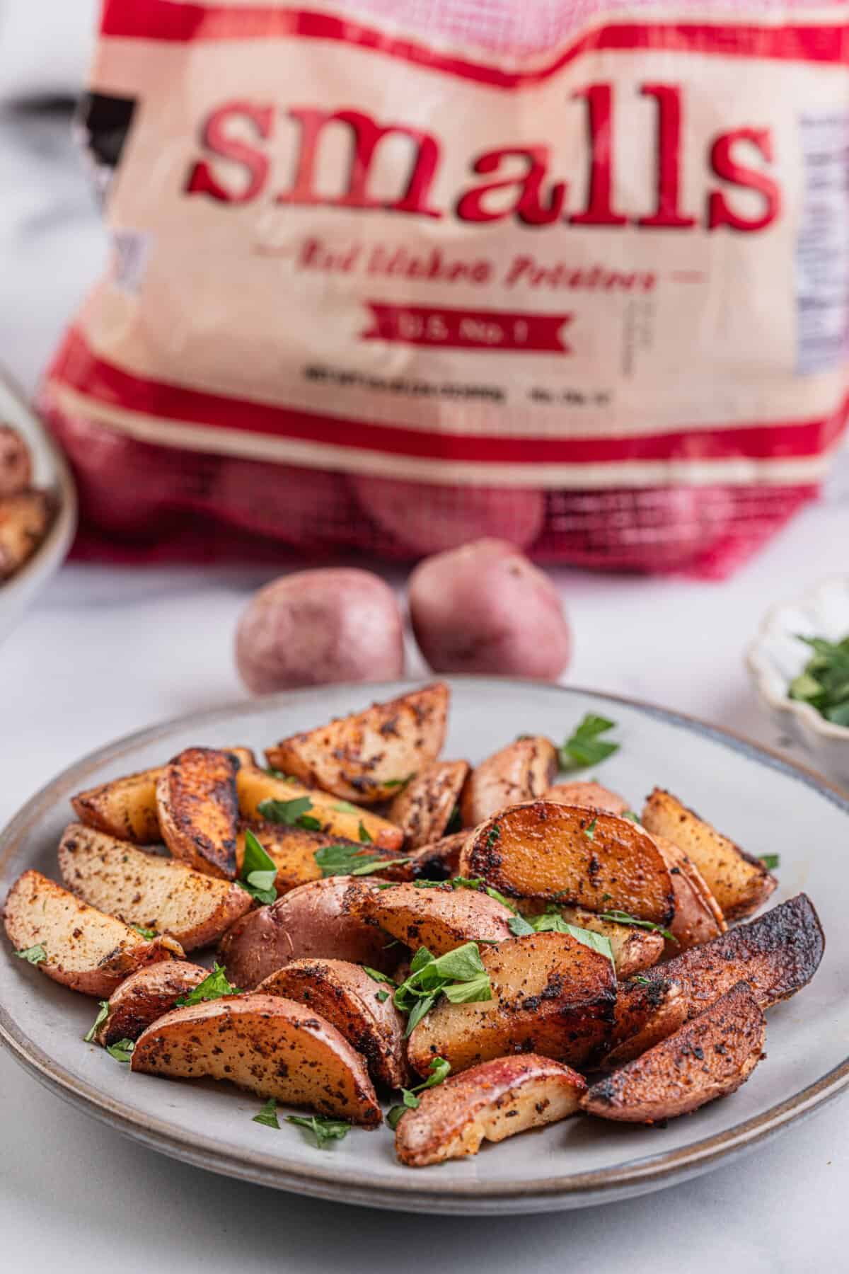 Breakfast potatoes garnished with fresh parsley on a plate.