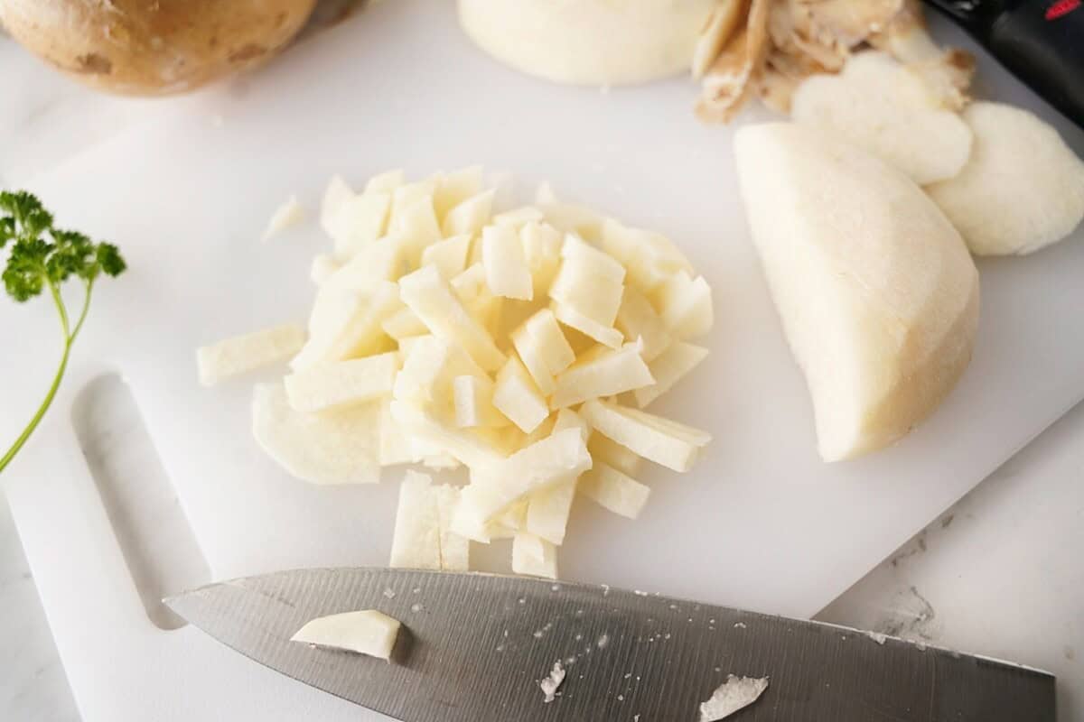 Diced jicama on white cutting board