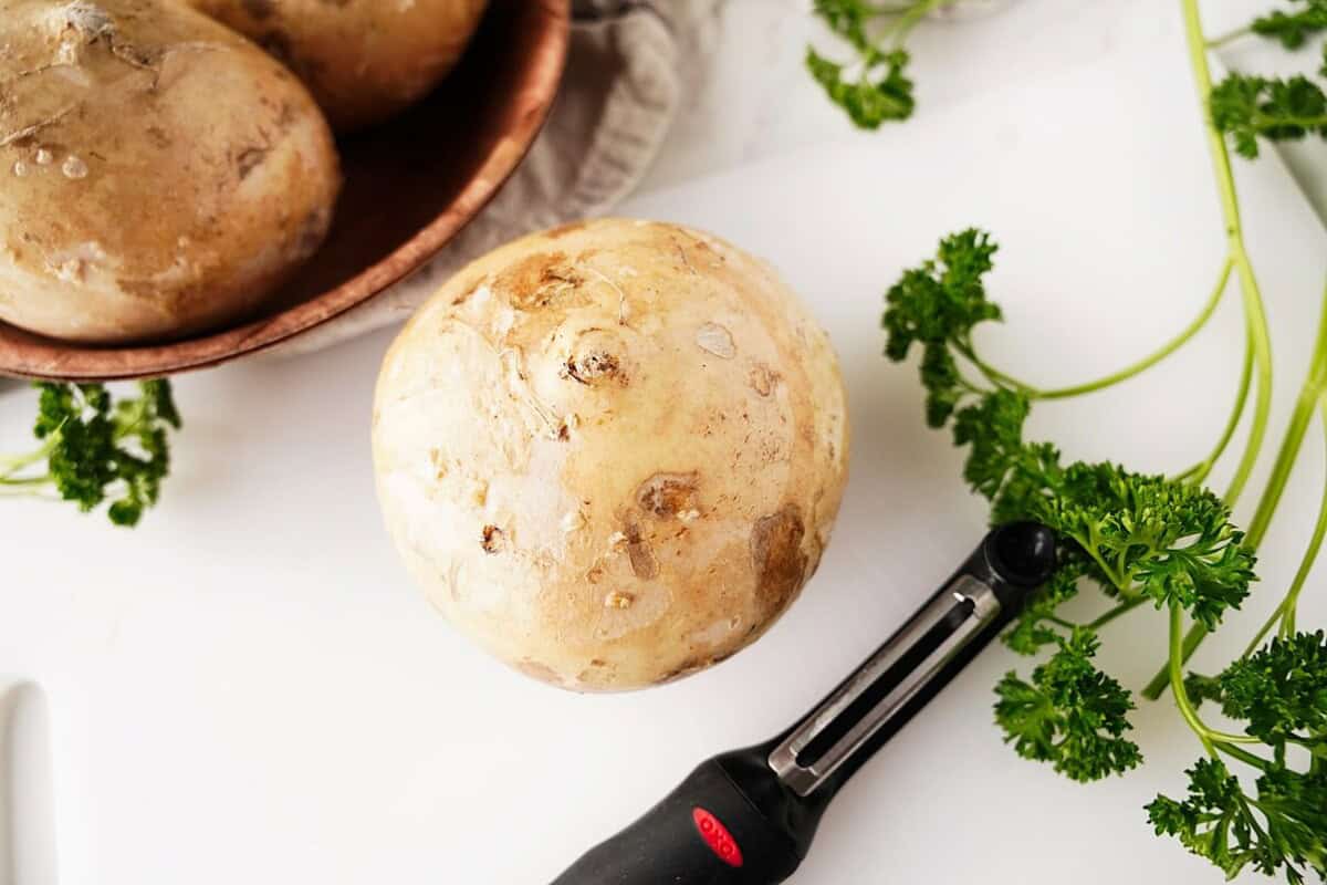 Whole jicama on cutting board