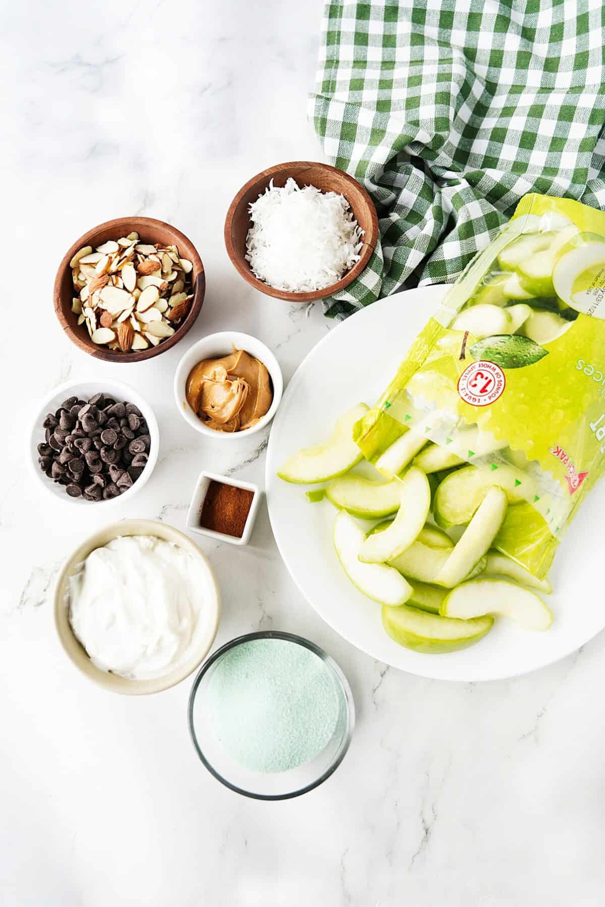 Green apple slices, shredded coconut, slivered almonds, chocolate chips, almond butter, cinnamon, Greek yogurt, lime jello 