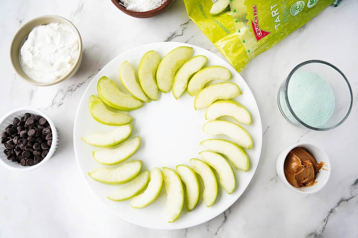 Apple slices in a ring on a plate.